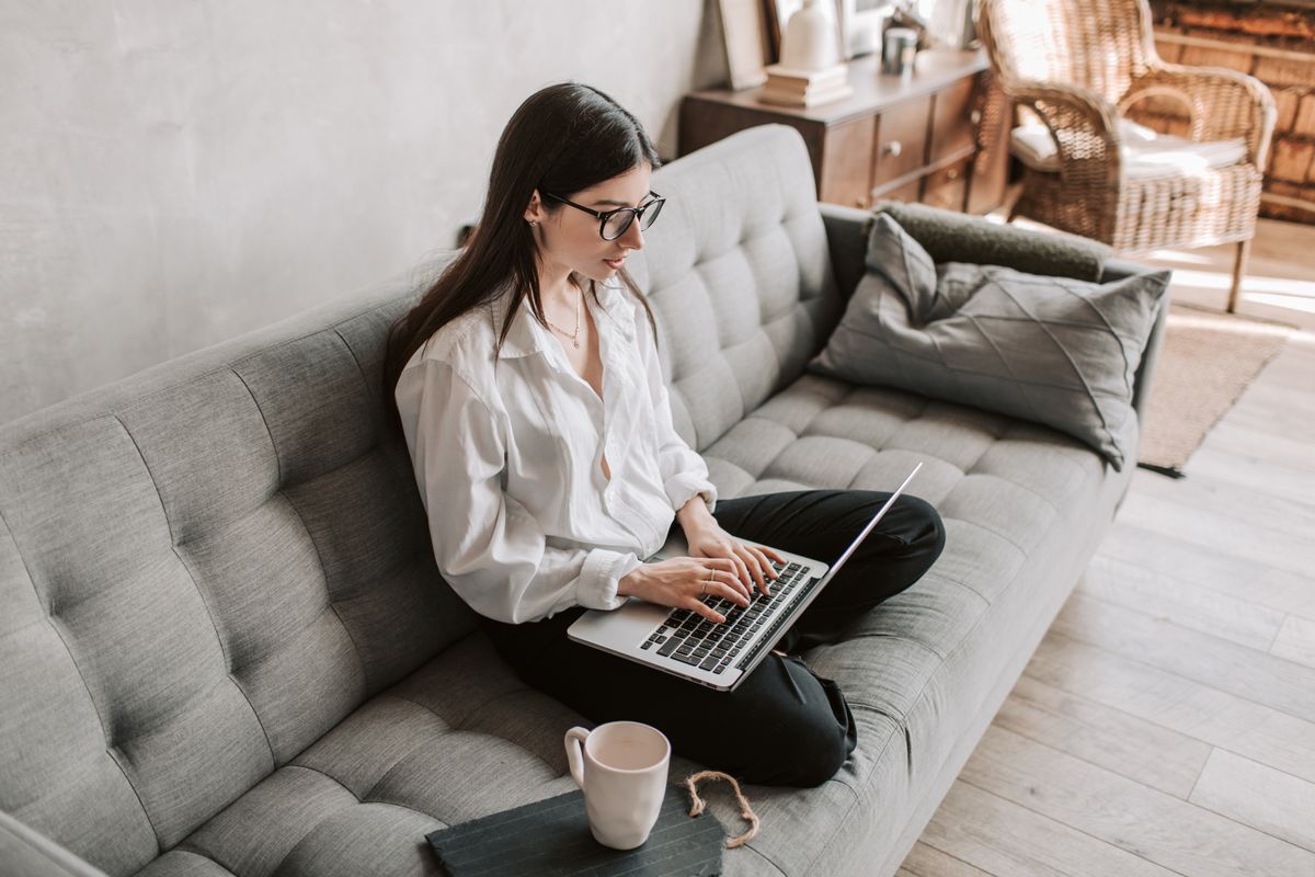 A laptop and a cup of coffee on a cafe table